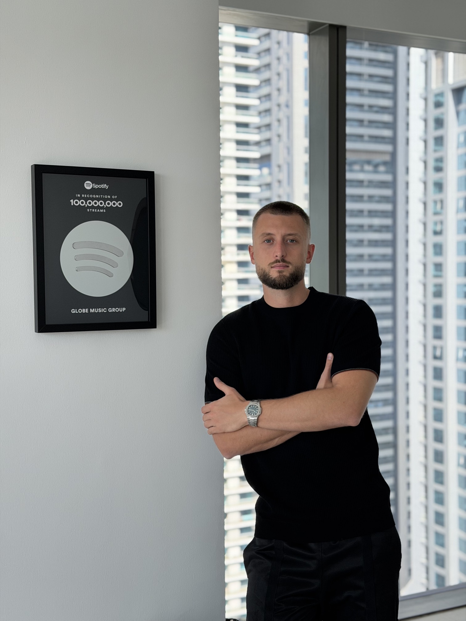 Ben Breternitz with the Spotify plaque in the Globe Music office